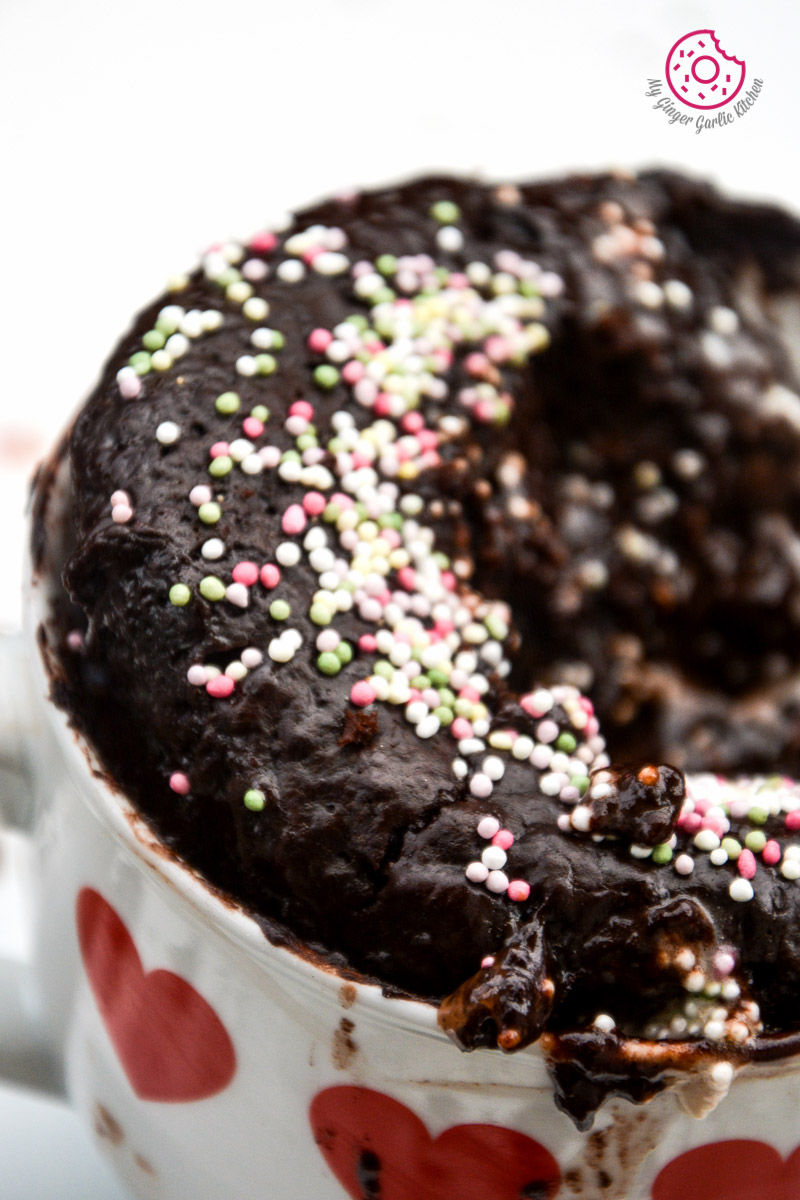 chocolate molten lava mug cake in a mug with sprinkles on it