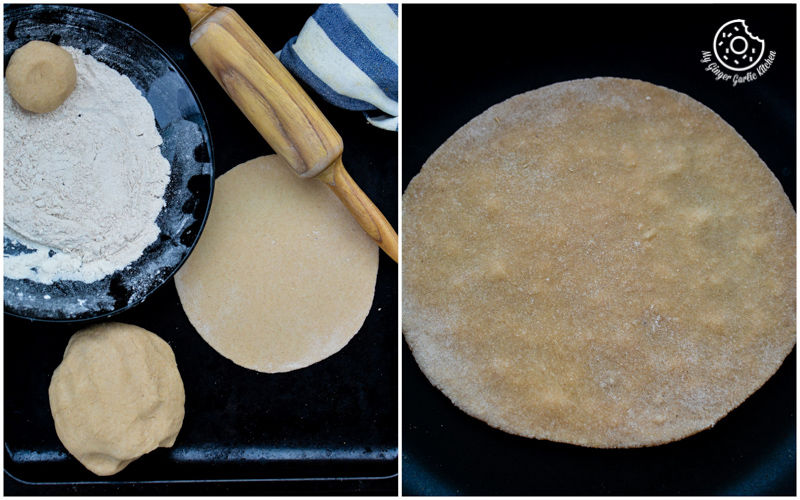 rolled chapati dough and a rolling pin on a black tray