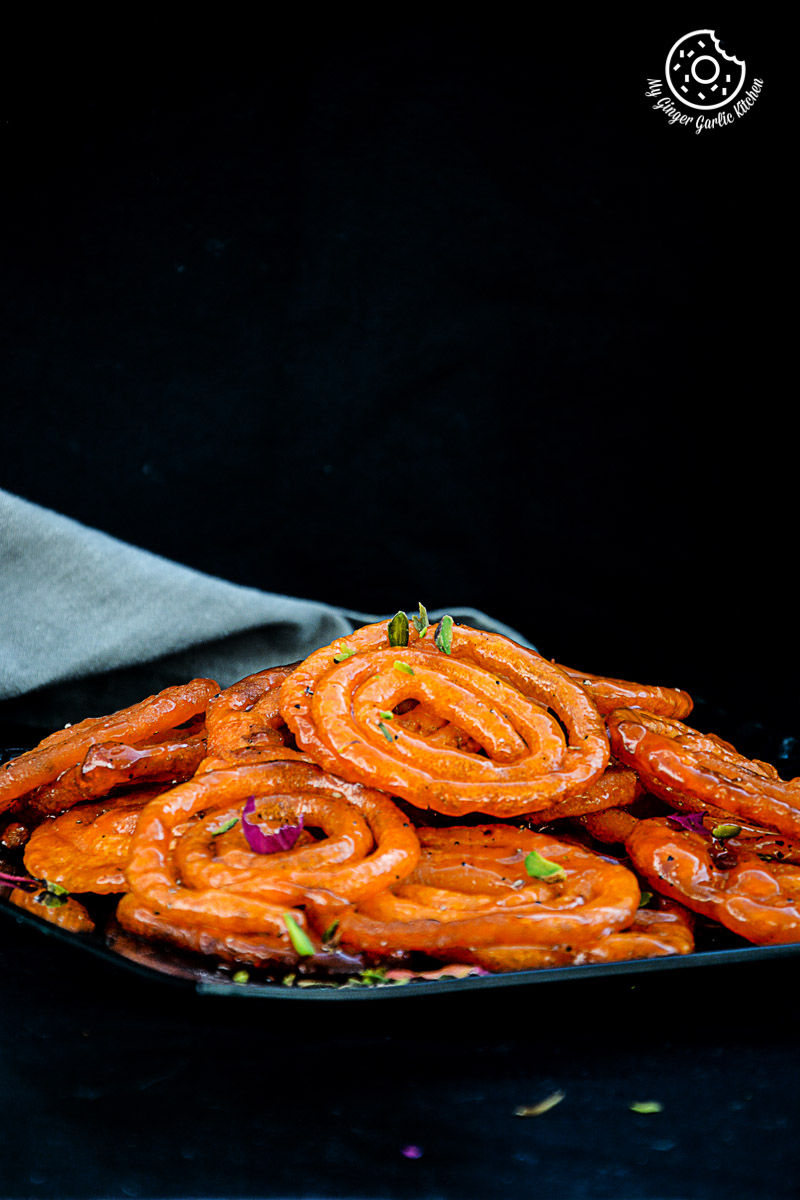 a plate of instant peach jalebi with a napkin in the background