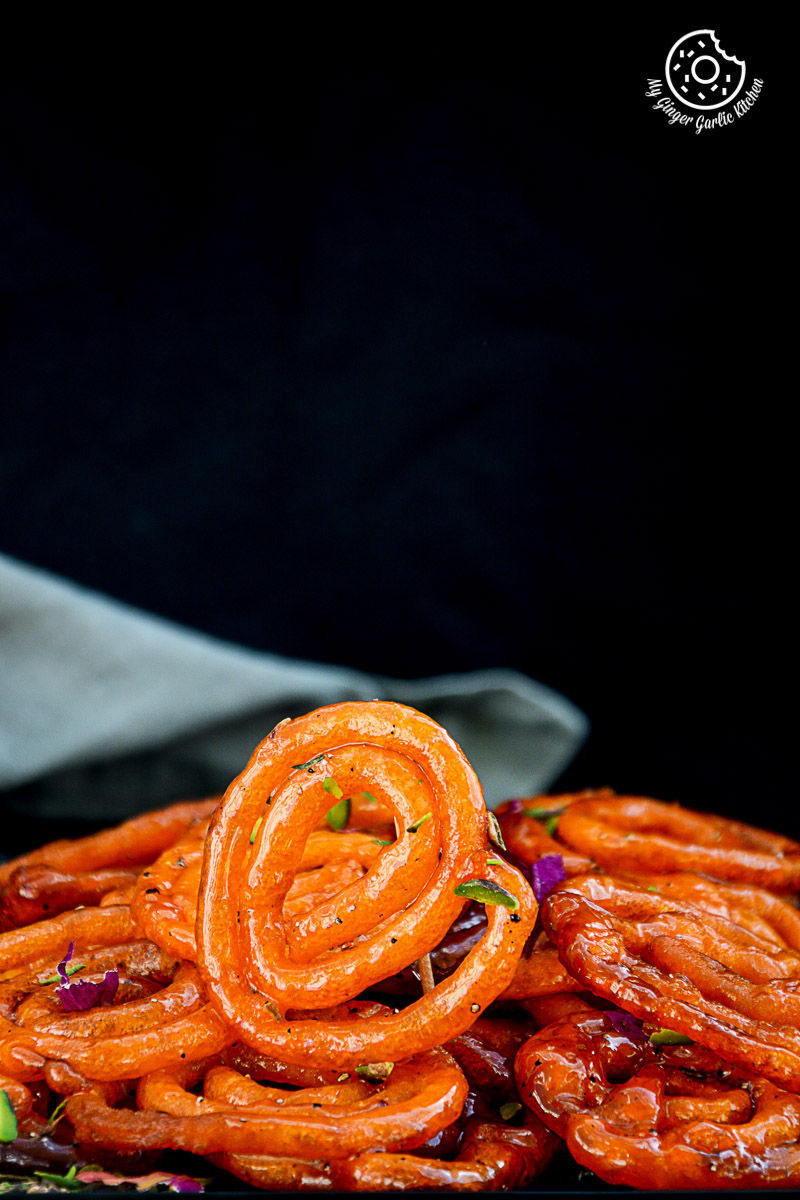 a pile of instant peach jalebis with a napkin in the background