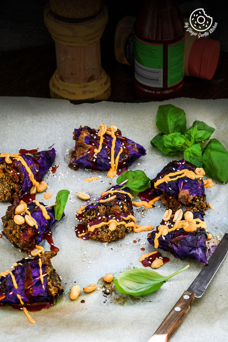 several pieces of potato panner stuffed roasted red cabbage cones on a cutting board with a knife