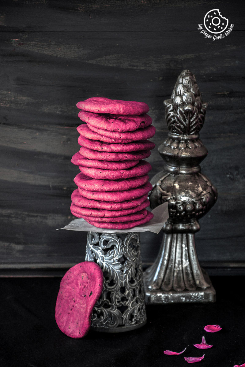 a stack of pink baked beet mathri sitting on a table