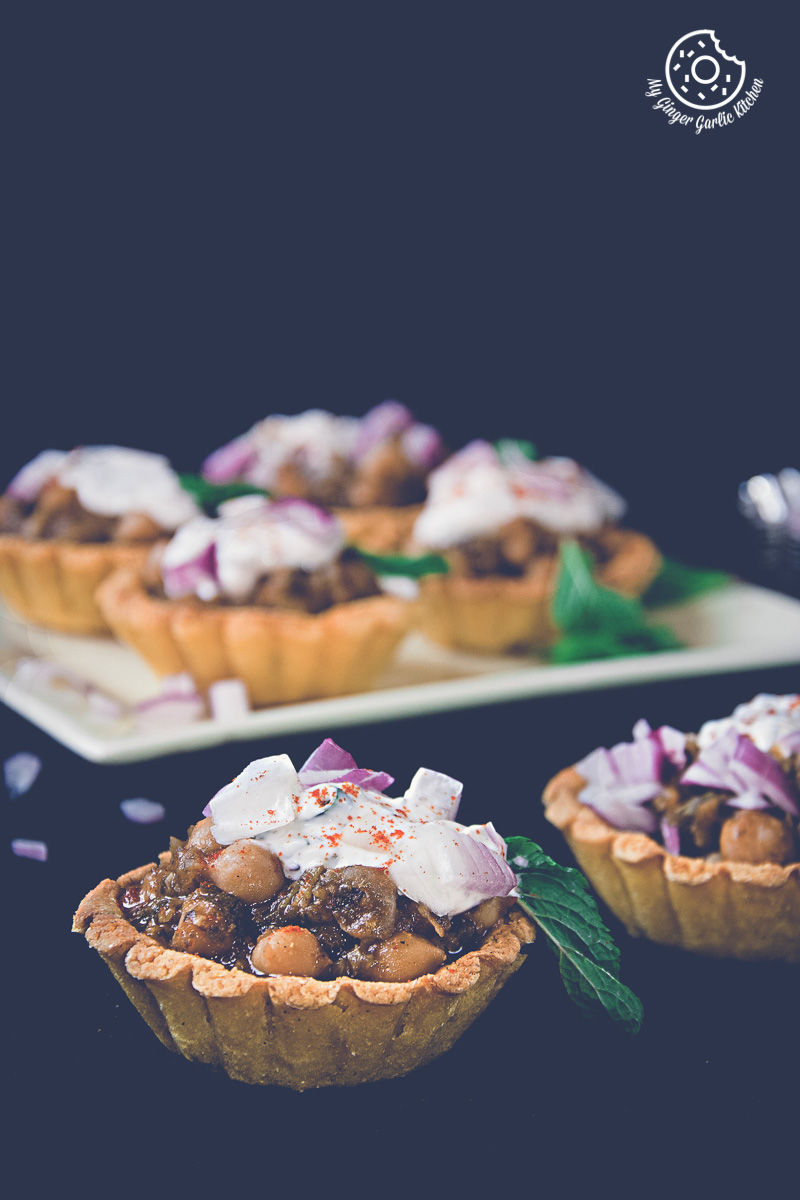 three small zero oil mint chola cornmeal tart with toppings on a table