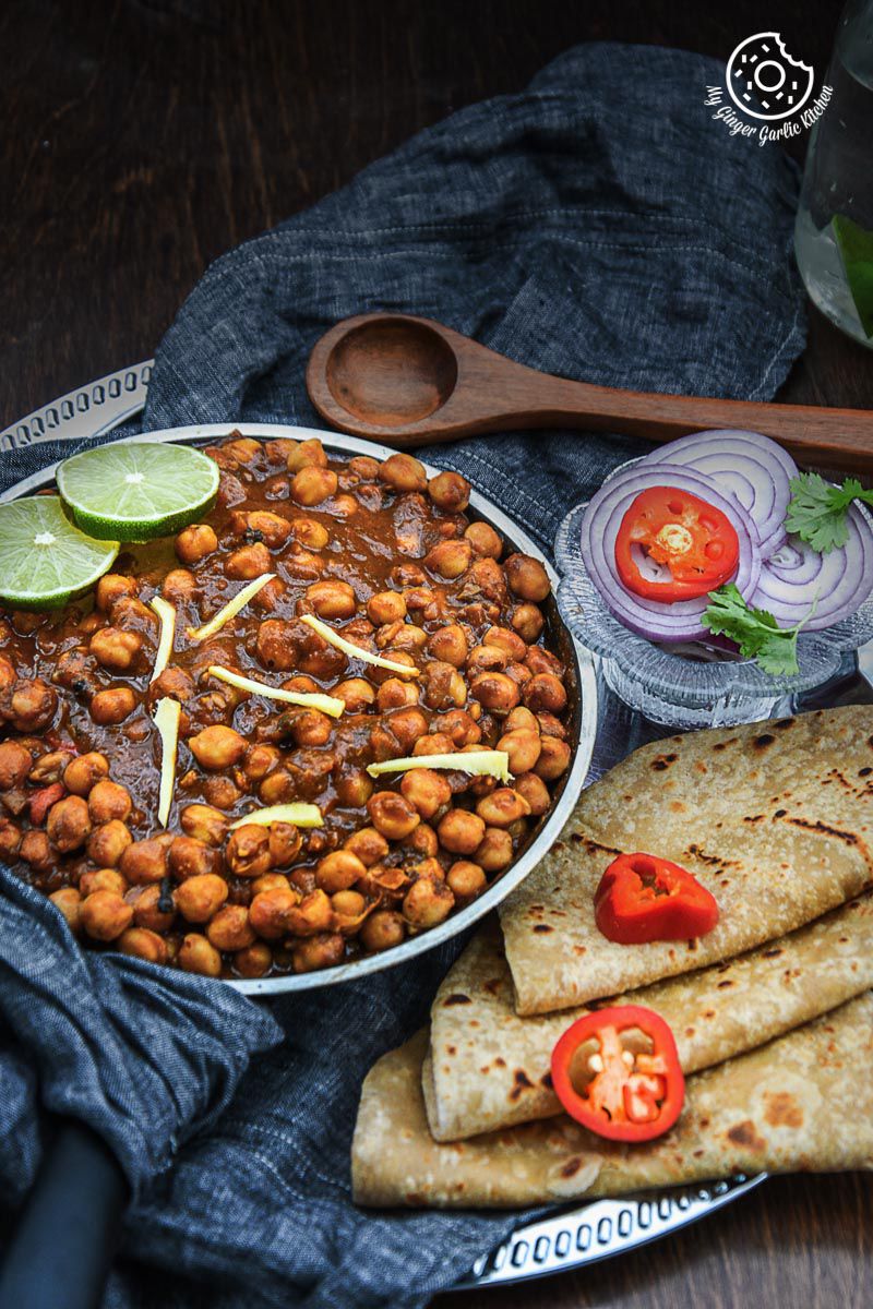 a plate of amritsari chole and parathas on it