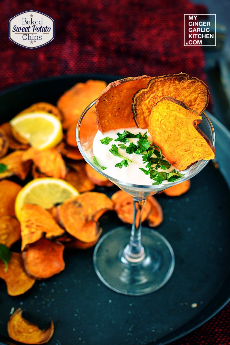 a glass of baked sweet potato chips with a dipping sauce on it
