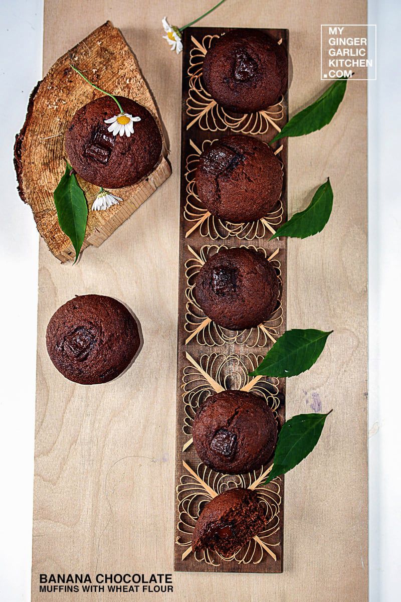 banana chocolate muffins with wheat flour on a wooden board with a flower