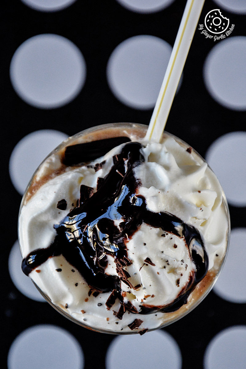 a banana coffee shake with whipped cream and chocolate syrup