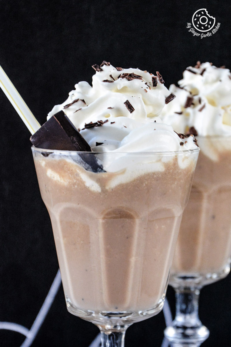 two glasses of banana coffee shake with whipped cream and chocolate