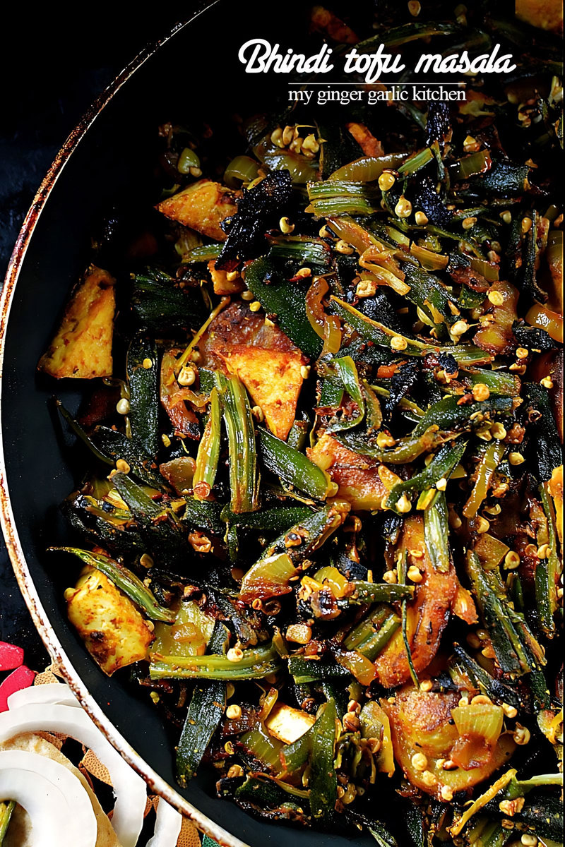 a pan with a bhindi tofu masala stir fry with onions