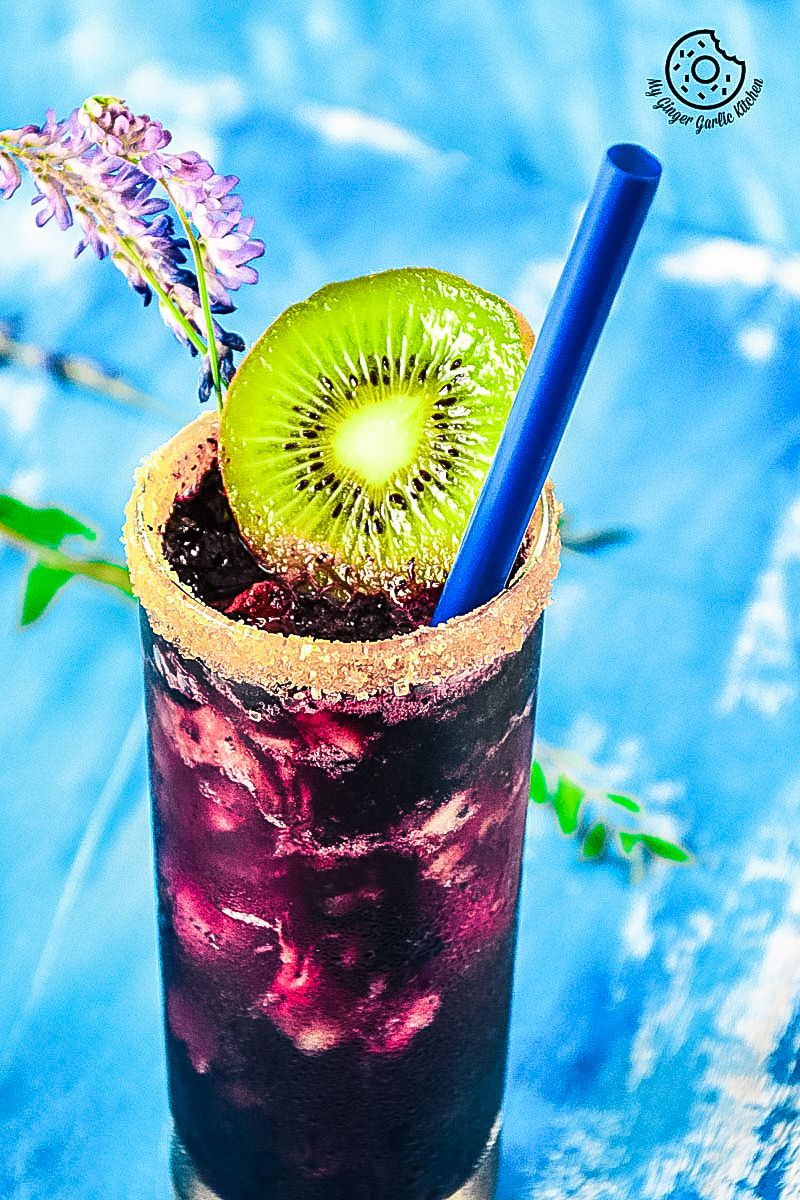 a blueberry kiwi cooler with a kiwi on top of it