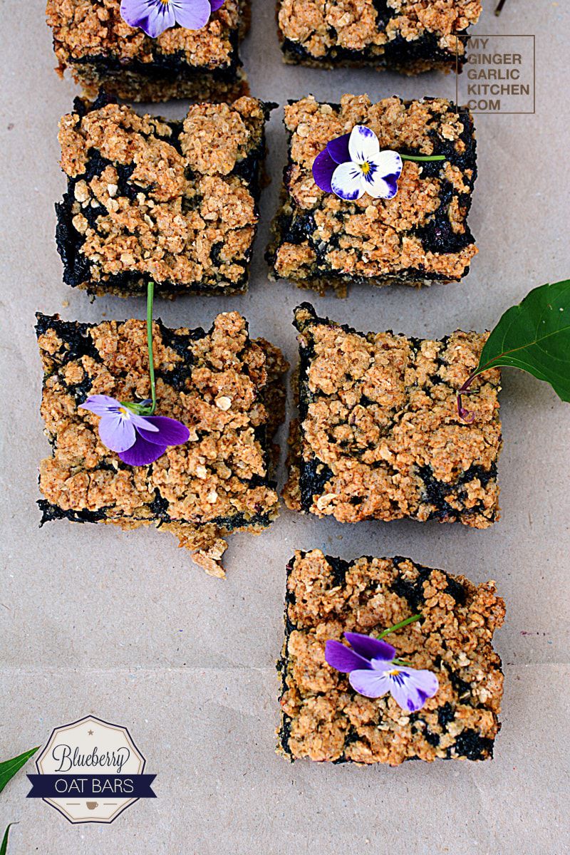 six squares of blueberry oat bars with flowers on them