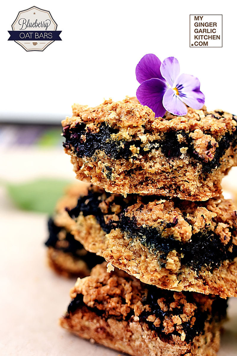 a stack of blueberry oat bars with a flower on top