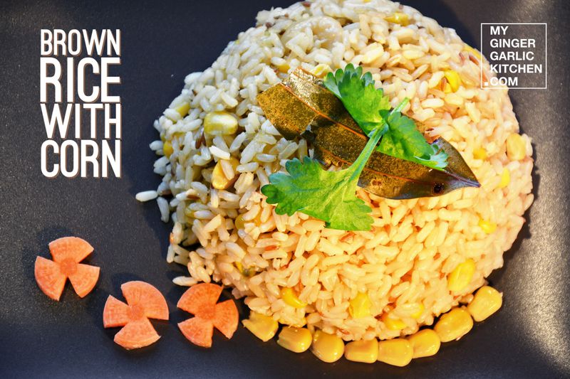 brown rice with corn on a brown plate with carrots