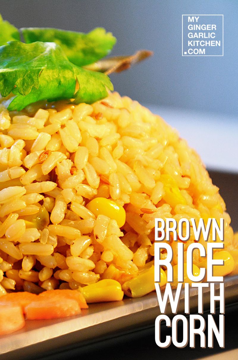 a plate of brown rice with corn on it