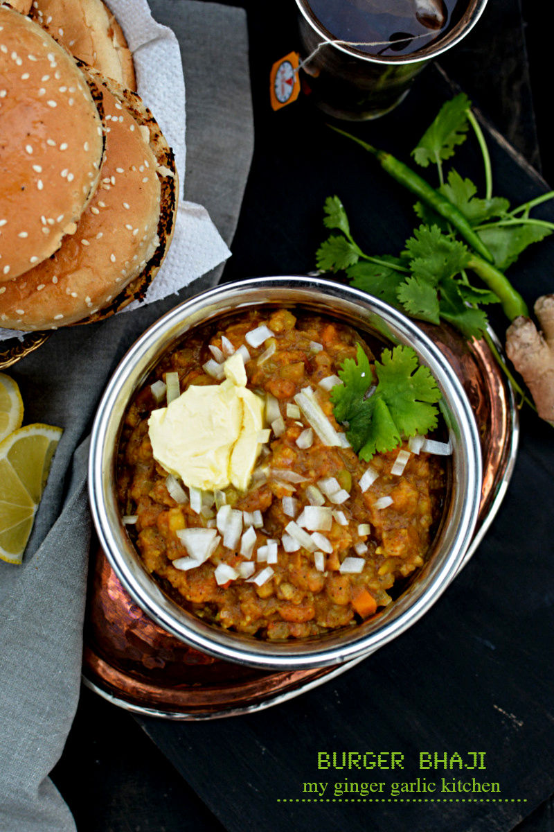 a hamburger and a bowl of burger bhaji on a table