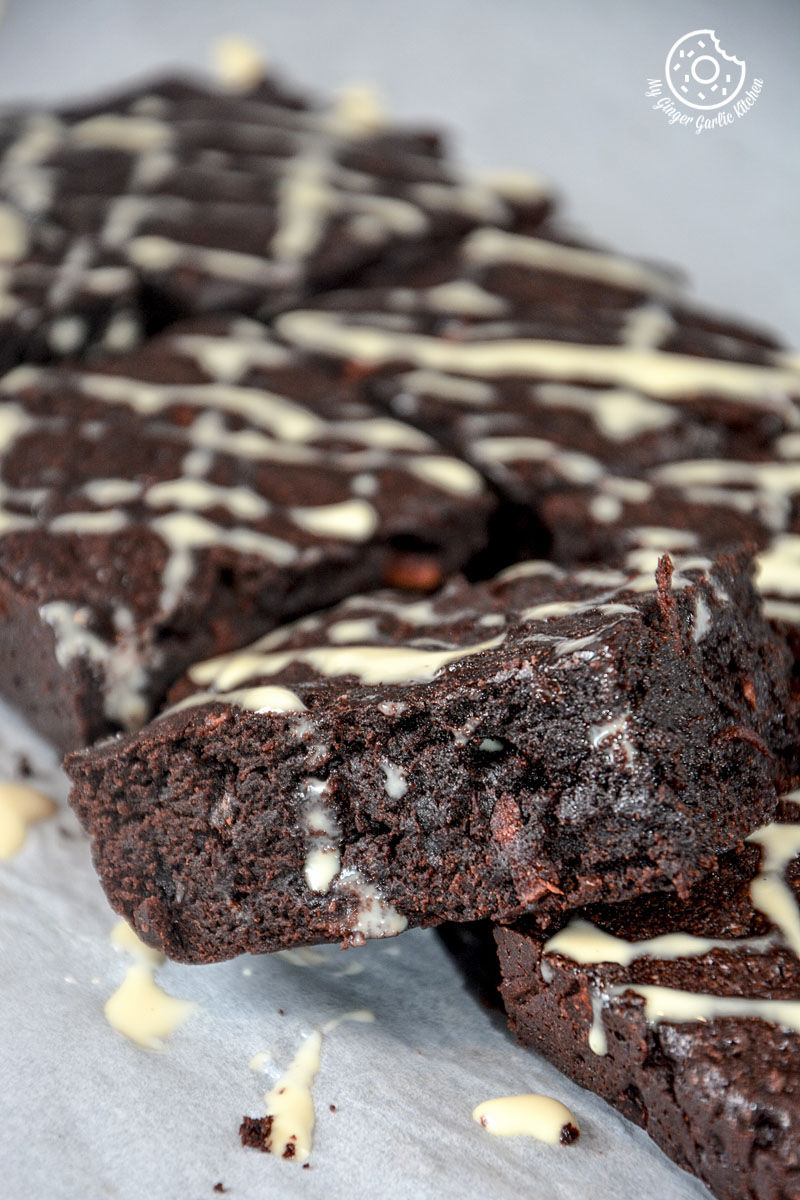 carrot chocolate brownies with white icing on a table