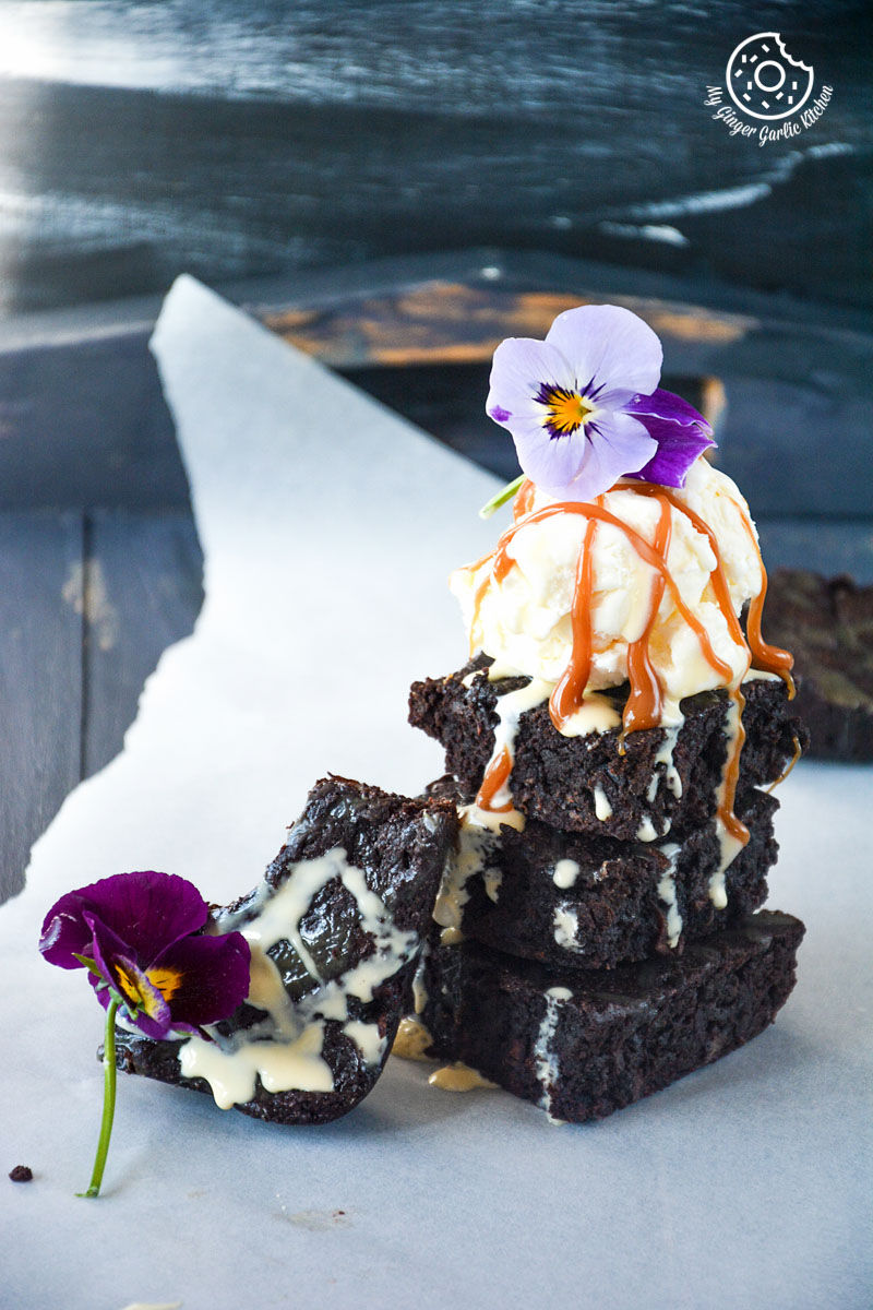 a stack of carrot brownies with a flower on top