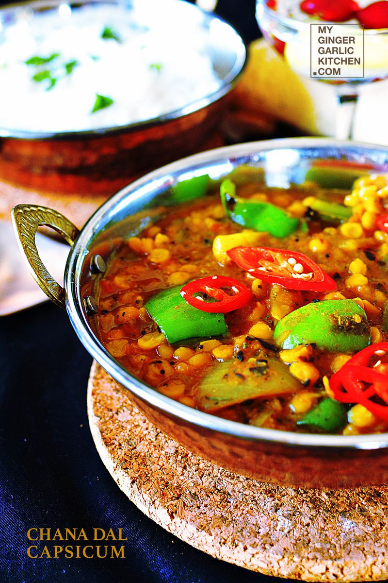 a bowl of chana dal capsicum curry topped with capsicum on a table