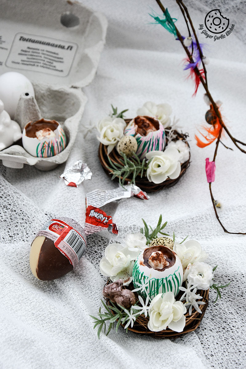 there are two small chocolate lassi egg cups with flowers and a chocolate egg