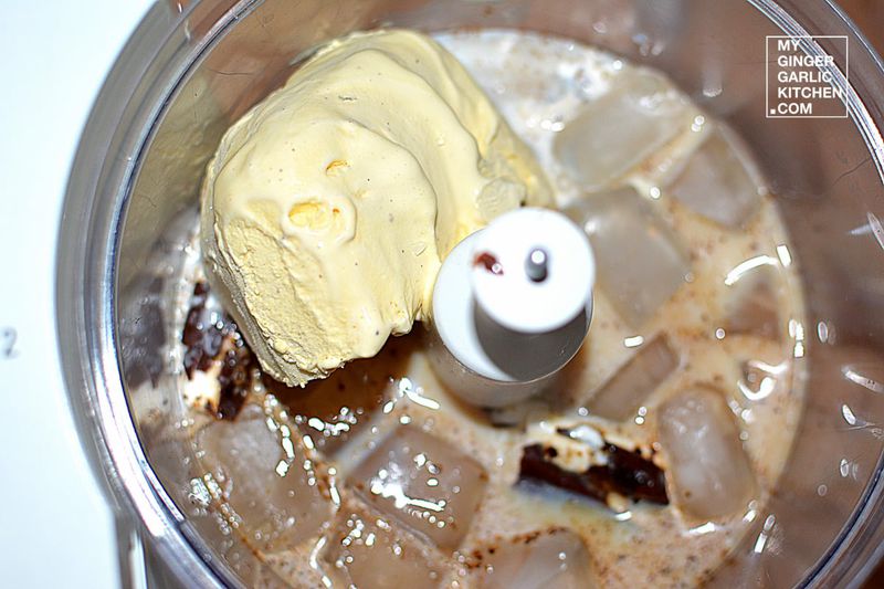 ice, milk, in a food processor with a scoop of ice cream