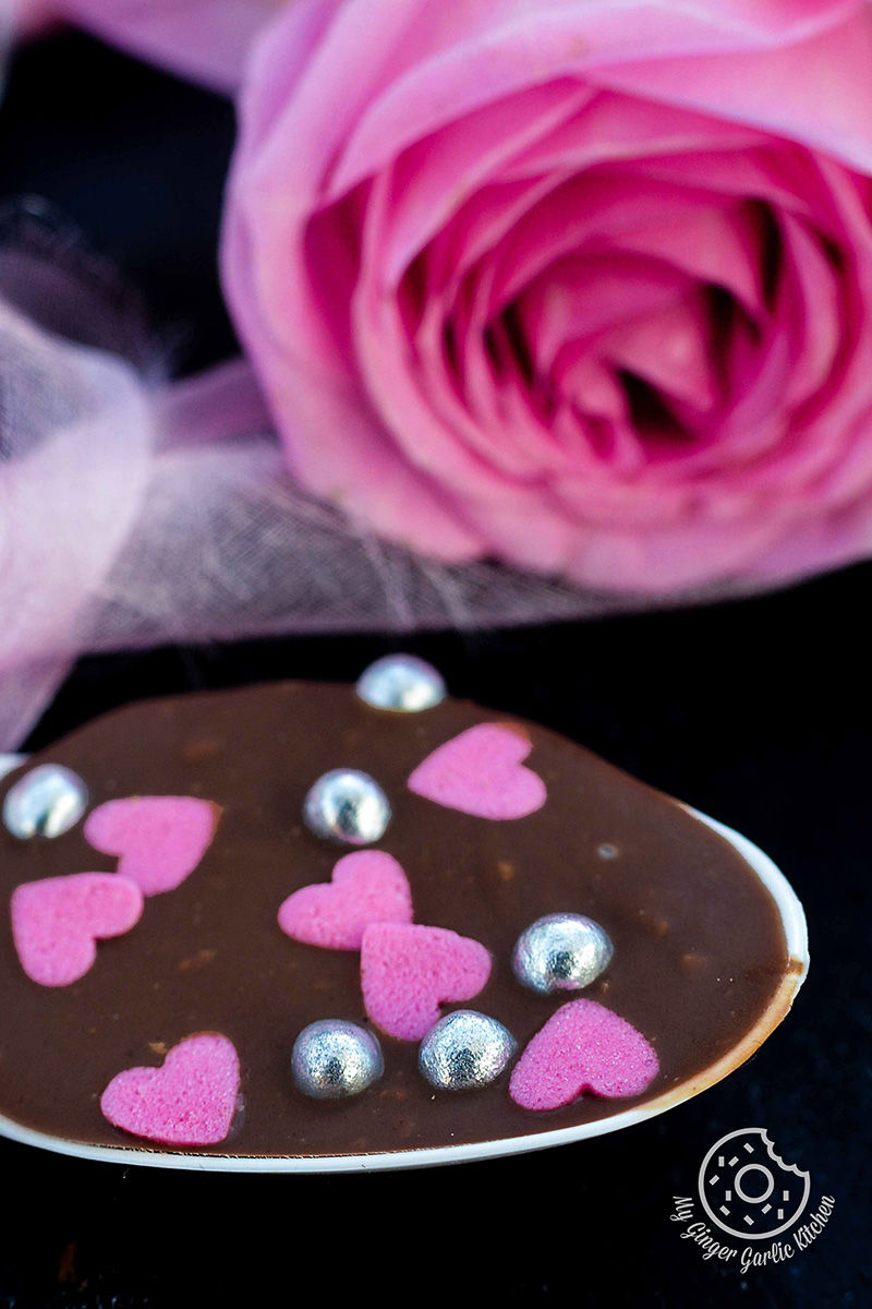 a chocolate spoon heart with pink hearts on it