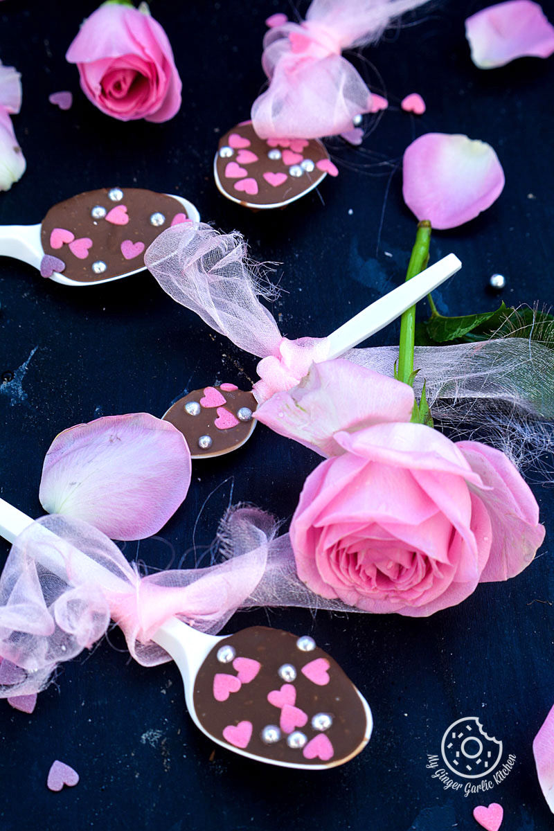 some chocolate spoons with pink flowers and hearts on them