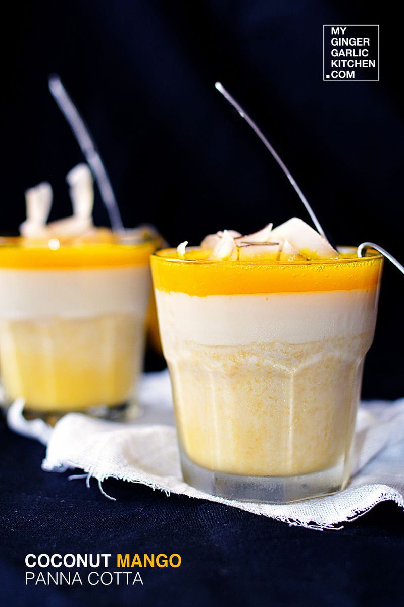 two cups of coconut mango panna cotta with coconut shavings on a napkin