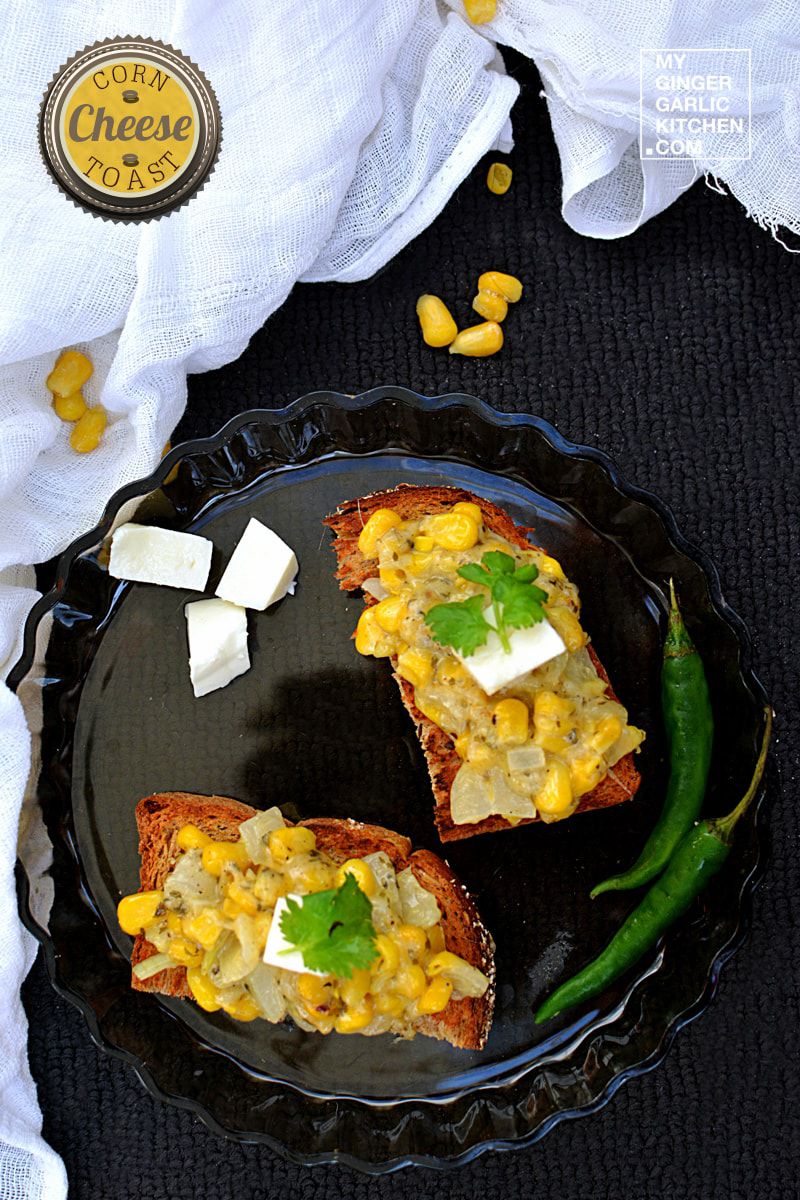 a plate with two pieces of corn cheese toast and a green herb on it