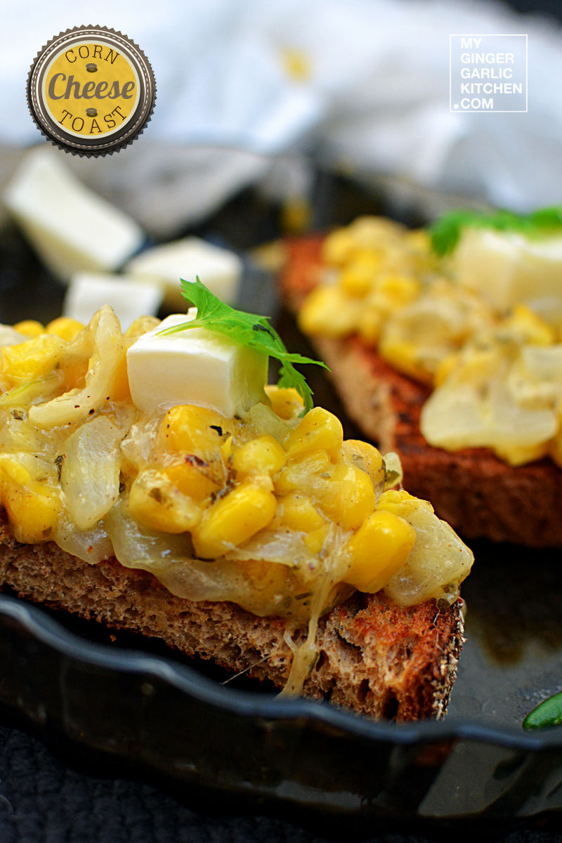 a plate with two pieces of corn cheese toast with corn and cheese