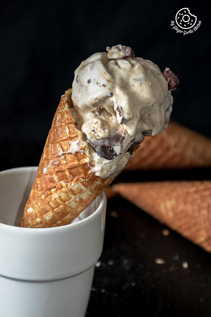 a cone with creamy coconut coffee chocolate chunk ice cream and chocolates in it