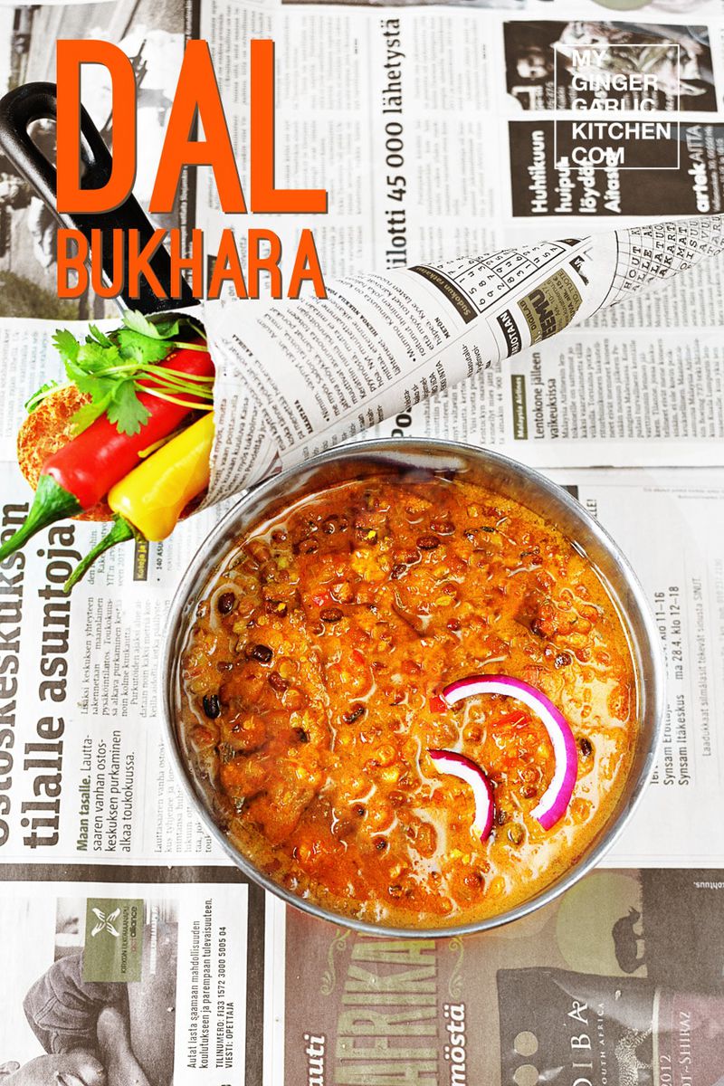 a bowl of dal bukhara with a newspaper in the background