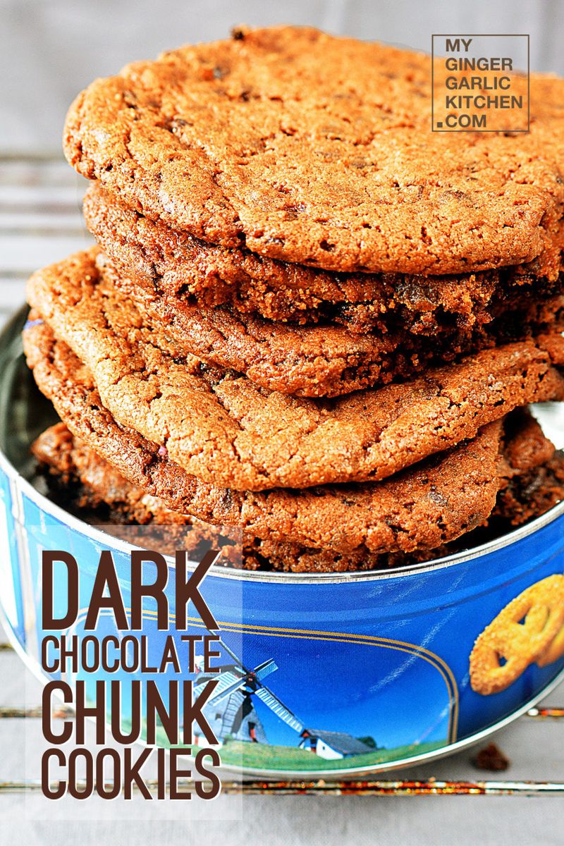 a tin of dark chocolate chunk cookies that are stacked up