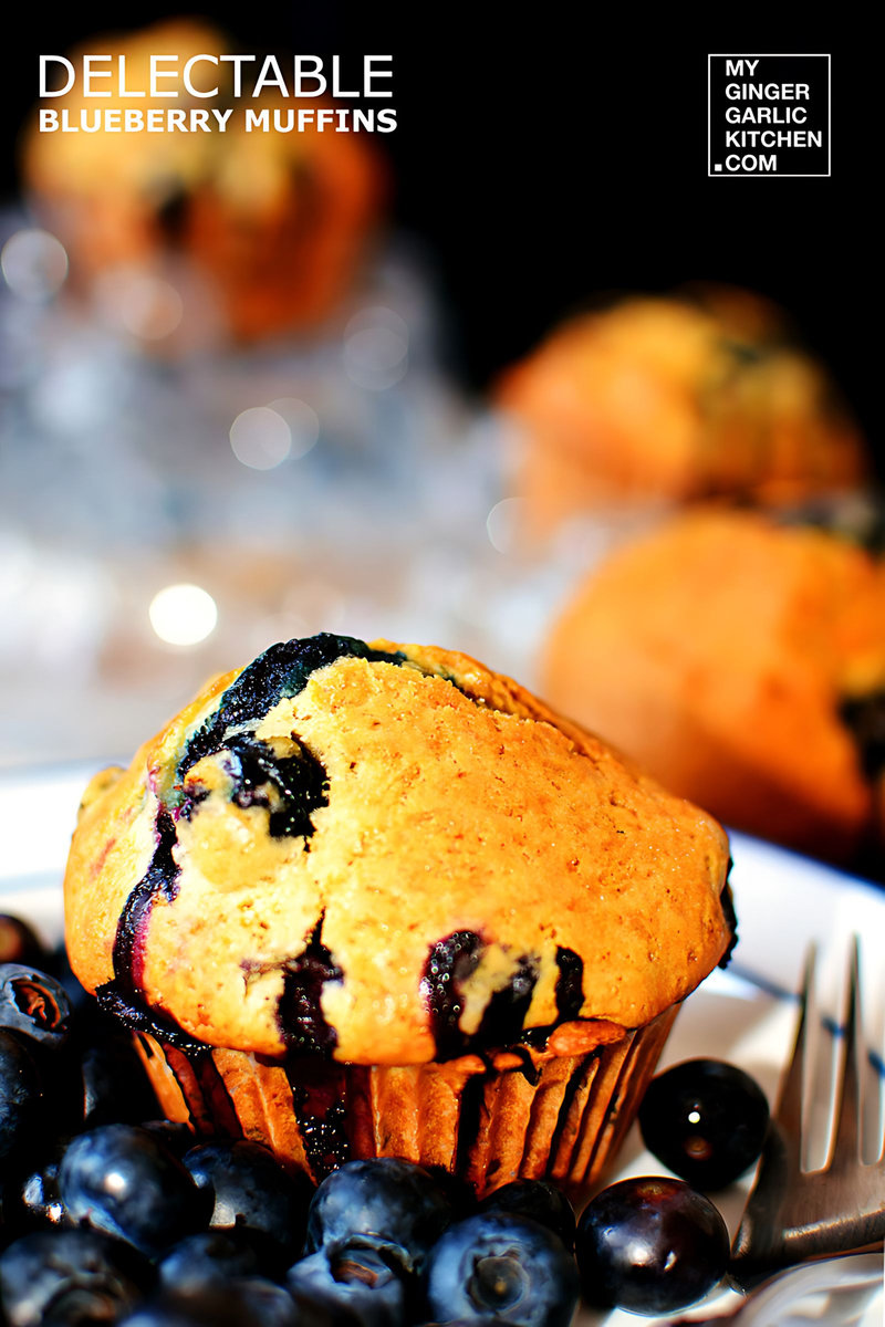a blueberry muffin on a plate with blueberries