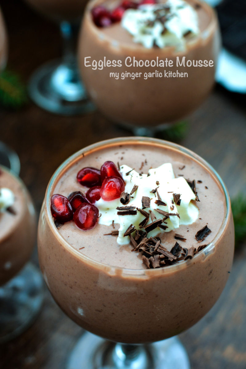 many glasses of eggless chocolate mousse with pomegranate seeds and chocolate