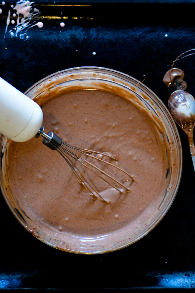 a bowl of chocolate and a whisk in it