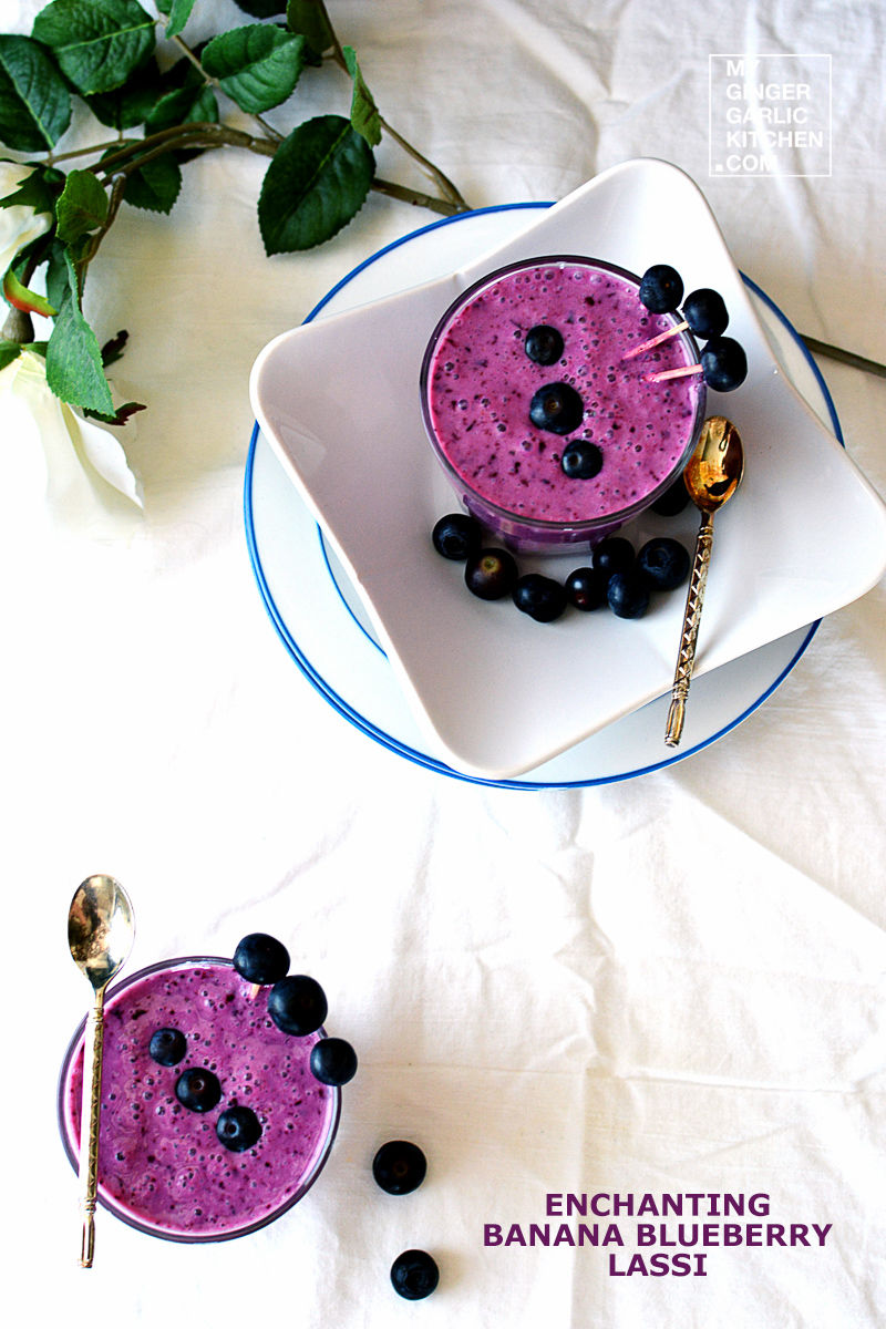 two banana blueberry lassis or blueberry smoothie glasses on plate