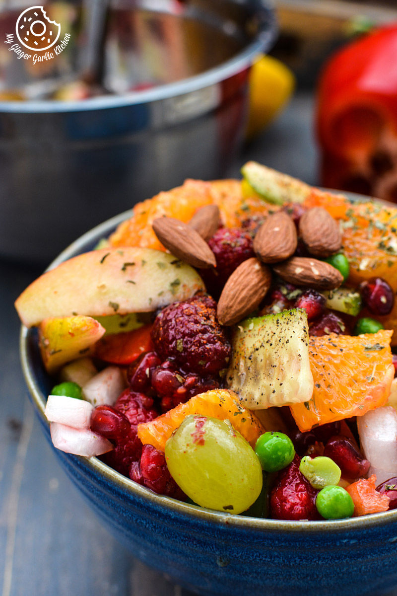 a bowl of fruits and vegetable fiesta salad with nuts and other fruits
