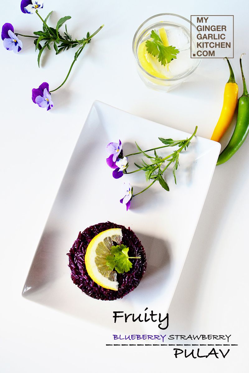 a plate with a fruity blueberry strawberry pulav on it and a flower