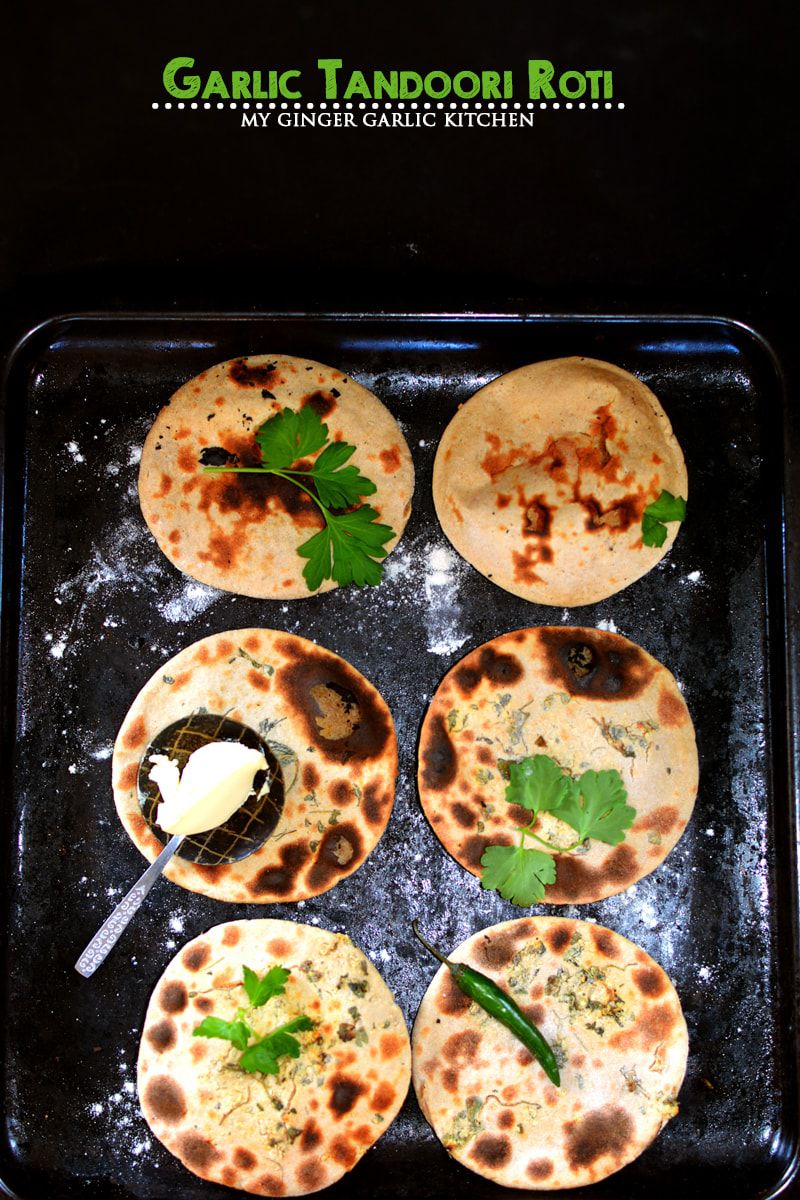 garlic tandoori roti with a cilantro of toppings and butter on a tray