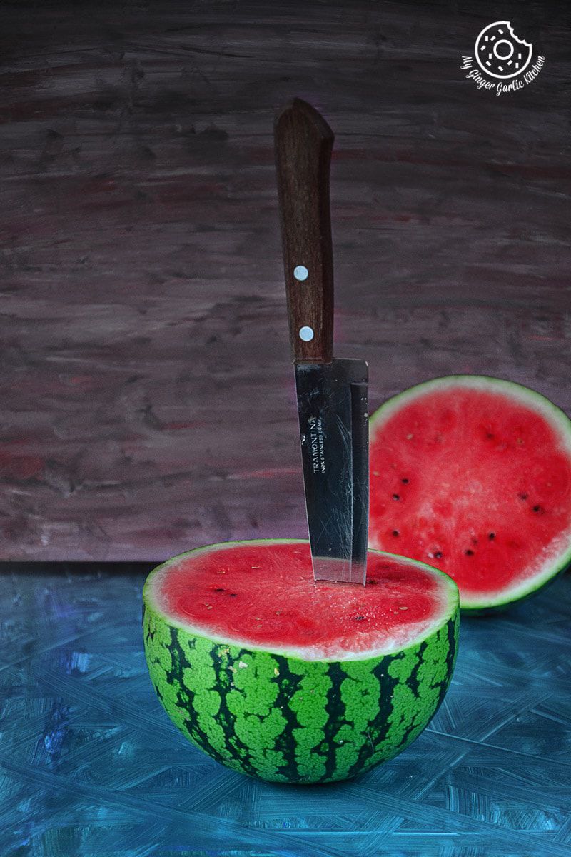 a knife stuck in a watermelon with a knife stuck in it