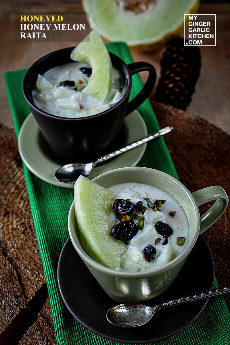 two cups of honeyed melon raita with a spoon kept on saucer