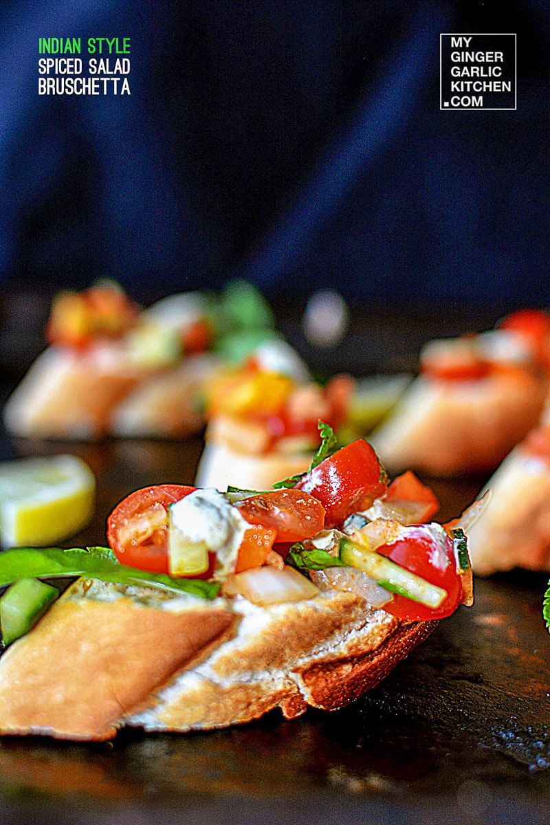 several pieces of indian style spiced salad bruschetta with vegetables on them