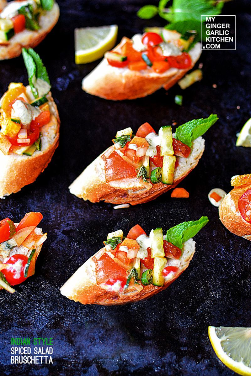 many pieces of indian style spiced salad bruschetta with different toppings on it