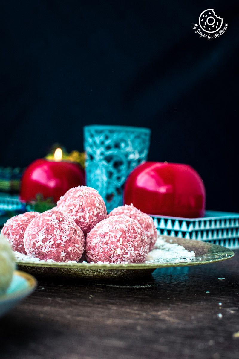 instant rose coconut ladoos on a plate on a table