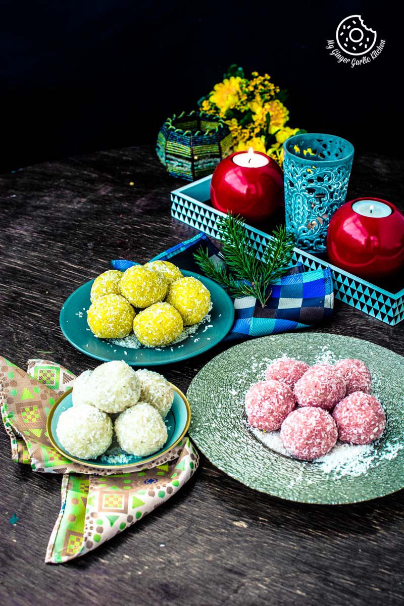 three plates instant coconut ladoos on a table with candles