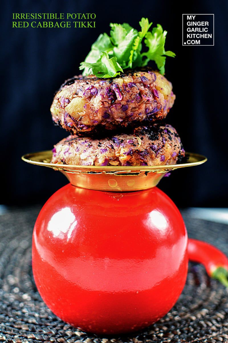 two potato red cabbage tikki stacked on top of each other with a green garnish