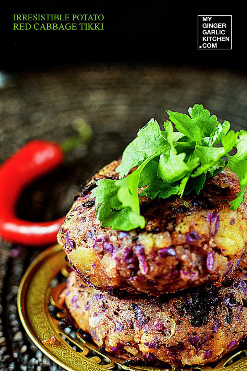 a plate with two potato red cabbage tikkis on it with a green garnish