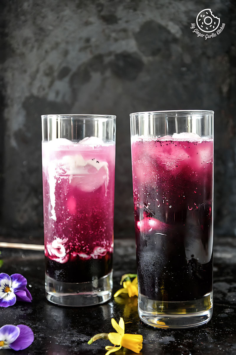 two glasses of italian cream soda with ice and flowers