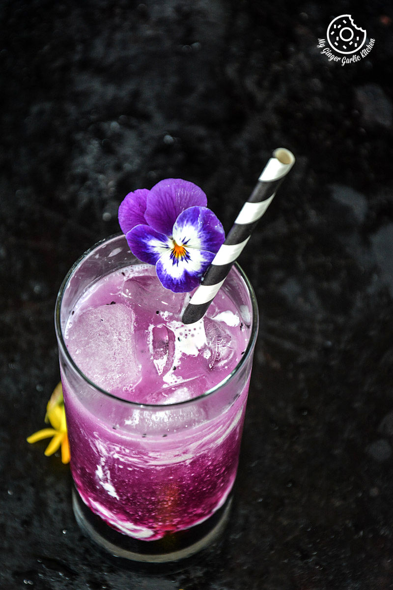 italian cream soda drink with a flower on top of it and a straw