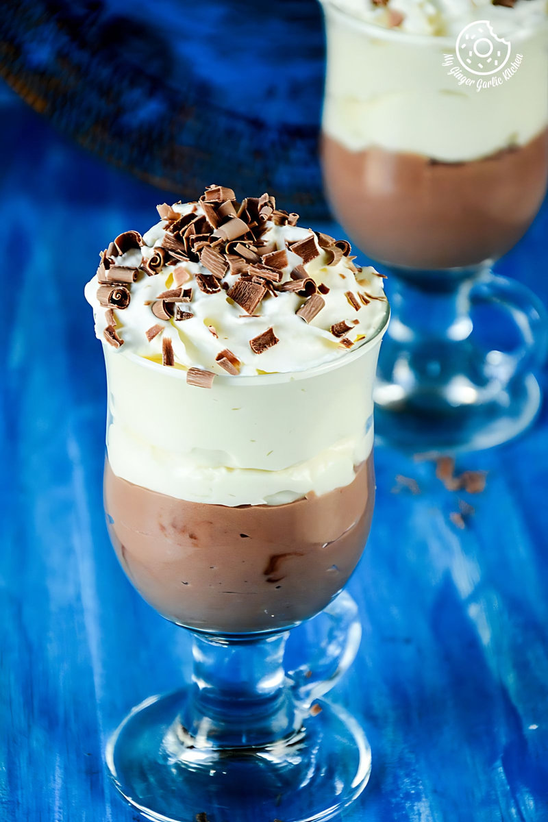 two mascarpone cream cheese chocolate mousse in a glasses on a blue table